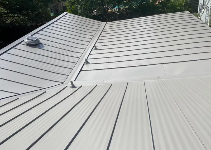 Solar attic fan installed on a metal roof for Roof Ventilation in Calumet